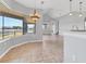 Light-filled dining area with chandelier, tile flooring and large window overlooking the backyard at 246 Petrel Trl, Bradenton, FL 34212