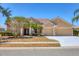 Charming one-story home with a red tile roof, well-manicured landscaping, and a two-car garage at 246 Petrel Trl, Bradenton, FL 34212