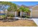 Inviting front entrance with landscaped garden and manicured lawn of a charming home at 246 Petrel Trl, Bradenton, FL 34212