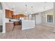 Open kitchen with stainless steel appliances, wooden cabinets, and a breakfast bar overlooking the dining area at 246 Petrel Trl, Bradenton, FL 34212