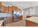 Kitchen with stainless steel appliances, wooden cabinets, and tile flooring at 246 Petrel Trl, Bradenton, FL 34212