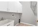 Laundry room with sink, cabinets and wire shelving at 246 Petrel Trl, Bradenton, FL 34212