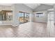 Open-concept living room with sliding glass doors and tile flooring throughout at 246 Petrel Trl, Bradenton, FL 34212