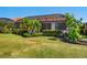 Lush backyard featuring well-maintained lawn, trimmed hedges, and a screened-in patio, perfect for outdoor enjoyment at 2525 Vaccaro Dr, Sarasota, FL 34231