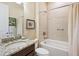 Bathroom with granite countertop, vanity, and shower with tub at 2525 Vaccaro Dr, Sarasota, FL 34231
