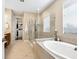 Luxurious bathroom features a soaking tub, glass shower, and elegant tile surround at 2525 Vaccaro Dr, Sarasota, FL 34231