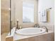 Elegant bathroom features a soaking tub, glass shower, and refined tile design at 2525 Vaccaro Dr, Sarasota, FL 34231