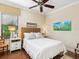 Bright bedroom features a ceiling fan, wood floors, and a lovely window with blind at 2525 Vaccaro Dr, Sarasota, FL 34231