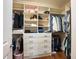 Walk-in closet with custom shelving, drawers, and ample storage space for clothes and accessories at 2525 Vaccaro Dr, Sarasota, FL 34231