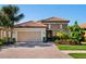 Charming single-story home featuring a tile roof, stone accents, a two-car garage and meticulous landscaping at 2525 Vaccaro Dr, Sarasota, FL 34231
