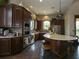 Resident kitchen featuring dark wood cabinets, a stainless steel oven and a view of the lounge at 2525 Vaccaro Dr, Sarasota, FL 34231