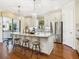 Bright kitchen features a large granite island, pendant lighting, stainless steel appliances, and lots of cabinet space at 2525 Vaccaro Dr, Sarasota, FL 34231