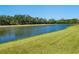 Picturesque lake view with lush green lawn in backyard at 2525 Vaccaro Dr, Sarasota, FL 34231