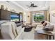 Open living room with comfortable seating, large TV, and a view of the outdoor patio through sliding glass doors at 2525 Vaccaro Dr, Sarasota, FL 34231