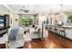 Spacious living area with hardwood floors, a comfortable sectional, and bar stool seating at the kitchen island at 2525 Vaccaro Dr, Sarasota, FL 34231