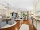 Open-concept living and dining area featuring hardwood floors, tray ceilings, and large windows, offering natural light at 2525 Vaccaro Dr, Sarasota, FL 34231