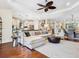 Expansive living area with hardwood floors, a comfortable sectional, and an open flow to the kitchen at 2525 Vaccaro Dr, Sarasota, FL 34231