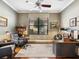 Home office with a built-in desk, bookcase, neutral wall color, and natural lighting at 2525 Vaccaro Dr, Sarasota, FL 34231