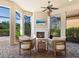 Outdoor living space with a fireplace, ceiling fans, and a nature view at 2525 Vaccaro Dr, Sarasota, FL 34231