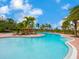 Beautiful swimming pool area with lounge chairs and palm trees around it, inviting and relaxing at 2525 Vaccaro Dr, Sarasota, FL 34231