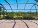 Large screened patio overlooking manicured backyard and tranquil lake at 2525 Vaccaro Dr, Sarasota, FL 34231
