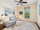 Cozy sitting room features a neutral palette, soft leather sofa, and large patterned rug at 2525 Vaccaro Dr, Sarasota, FL 34231