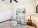 A stylish sitting room with a soft leather sofa, decorative rug, and a large window at 2525 Vaccaro Dr, Sarasota, FL 34231