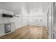 Bright, spacious living area featuring light wood laminate floors and access to a sleek white kitchen at 2601 Gulf N Dr # 317, Bradenton Beach, FL 34217