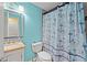 Colorful bathroom with a shower featuring anchor-themed curtains and a vanity at 28442 Coco Palm Dr, Punta Gorda, FL 33982