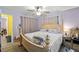 Spacious bedroom with a large bed, ceiling fan, and access to an ensuite bathroom at 28442 Coco Palm Dr, Punta Gorda, FL 33982