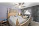 Spacious bedroom with an updated ceiling fan, decorative wall, and large bed at 28442 Coco Palm Dr, Punta Gorda, FL 33982