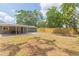 Expansive backyard with a well-maintained lawn, bordered by a wooden fence, providing privacy and space for outdoor activities at 301 89Th Ne Ave, St Petersburg, FL 33702