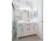 Modern bathroom with white vanity and marble tile walls, complete with bathtub/shower combo at 301 89Th Ne Ave, St Petersburg, FL 33702