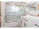 Bathroom featuring modern vanity with black hardware and bathtub with sliding glass door at 301 89Th Ne Ave, St Petersburg, FL 33702
