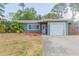 Charming single-story home with a well-kept front lawn, updated paint, and a one car garage at 301 89Th Ne Ave, St Petersburg, FL 33702