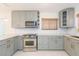 Well-lit kitchen featuring modern stainless steel appliances, custom cabinets and marble counter tops at 301 89Th Ne Ave, St Petersburg, FL 33702