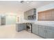 Spacious kitchen with marble counter tops, stainless steel appliances, custom cabinets, and tile floors at 301 89Th Ne Ave, St Petersburg, FL 33702