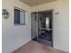 The private front porch of Unit 314 showing the front door and storm door at 340 Base E Ave # 314, Venice, FL 34285