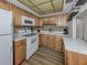 Efficiently designed kitchen with wooden cabinets, modern appliances, and sleek countertops for an easy flow at 340 Base E Ave # 314, Venice, FL 34285