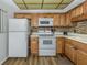 Efficiently designed kitchen with wooden cabinets, modern appliances, and sleek countertops for an easy flow at 340 Base E Ave # 314, Venice, FL 34285