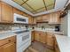 Efficiently designed kitchen with wooden cabinets, modern appliances, and sleek countertops for an easy flow at 340 Base E Ave # 314, Venice, FL 34285