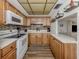 Efficiently designed kitchen with wooden cabinets, modern appliances, and sleek countertops for an easy flow at 340 Base E Ave # 314, Venice, FL 34285