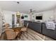 Inviting living room with a glass dining table and an elegant gray couch complemented by updated flooring at 340 Base E Ave # 314, Venice, FL 34285