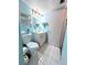 Blue-toned bathroom with a toilet, vanity, and decor shelves at 3559 Lake Bayshore Dr # J-204, Bradenton, FL 34205