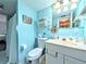 Light blue bathroom featuring a vanity, toilet, and shower at 3559 Lake Bayshore Dr # J-204, Bradenton, FL 34205