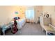 Cozy bedroom with a single bed, carpeted floors, natural light, and simple decor at 3559 Lake Bayshore Dr # J-204, Bradenton, FL 34205