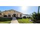 Exterior of the community clubhouse with landscaped yard, sidewalk, and building at 3559 Lake Bayshore Dr # J-204, Bradenton, FL 34205