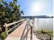 Scenic view of the wooden dock, waterfront, and building in this community at 3559 Lake Bayshore Dr # J-204, Bradenton, FL 34205