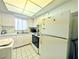 Functional kitchen with standard appliances and a white washer dryer combo for added convenience at 3559 Lake Bayshore Dr # J-204, Bradenton, FL 34205