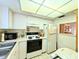 An efficient kitchen features standard appliances, including a refrigerator and range, along with ample counter space at 3559 Lake Bayshore Dr # J-204, Bradenton, FL 34205